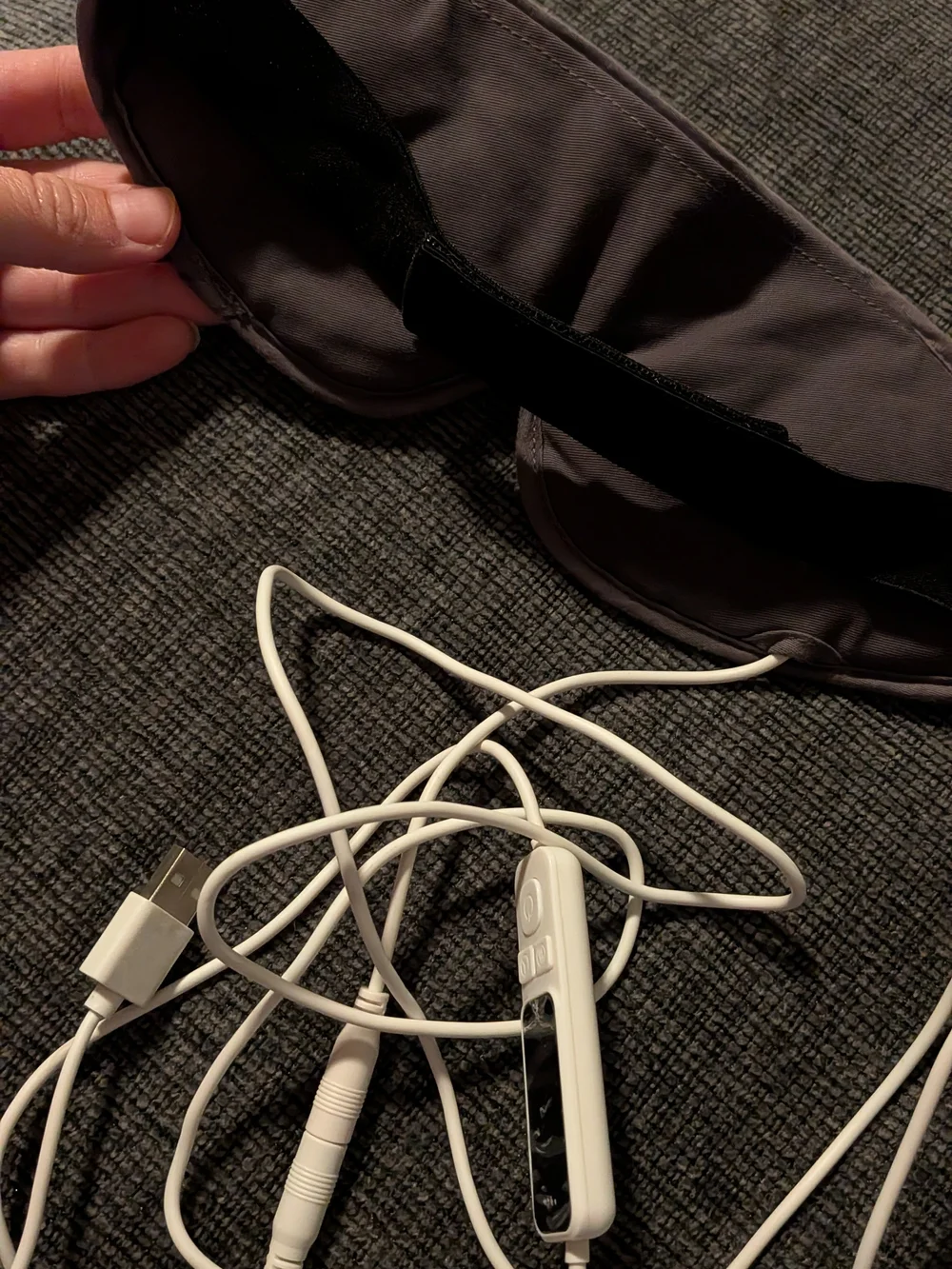 gray UNCN Heated Eye Mask featuring an attached USB cord and inline temperature/